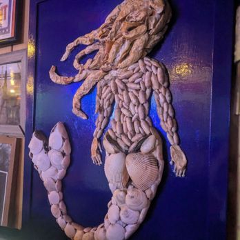 Planet Follywood - a mermaid made out of seashells - Burgers Near Me - Folly Beach, South Carolina Planet Follywood - a mermaid made out of seashells - Burgers Near Me - Folly Beach, South Carolina