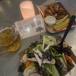 Chicken wings, salad, Mexican lager Chicken wings, salad, Mexican lager
