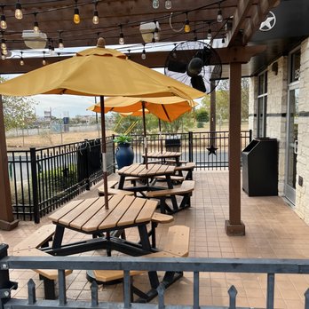 Golden Chick - a patio with tables and umbrellas - Fast Food Near Me - La Vernia, Texas Golden Chick - a patio with tables and umbrellas - Fast Food Near Me - La Vernia, Texas