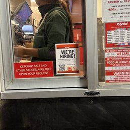 a woman wearing a face mask in a store window