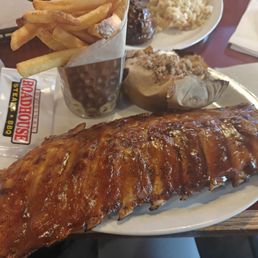 Baby back ribs with baked sweet potato and fries. Baby back ribs with baked sweet potato and fries.