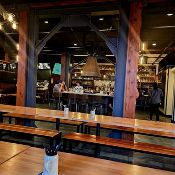 Berliner Beerhall - There is a fire in the center and seats around it. - German Near Me - Tacoma, Washington
