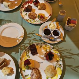 2 sweets plate. One with rosemary scone, the other with lemon. Kitchen mix up. Still delicious. Had to ask for creme and jelly.