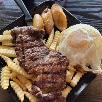 Latin Chef Peruvian Cuisine - Bistek a lo pobre (steak, French fries, plantains, fried egg and white rice) - Peruvian Near Me - Oceanside, California Latin Chef Peruvian Cuisine - Bistek a lo pobre (steak, French fries, plantains, fried egg and white rice) - Peruvian Near Me - Oceanside, California