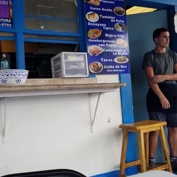Pupuseria Alondra - a man standing in front of a food stand - Salvadoran Near Me - Orlando, Florida
