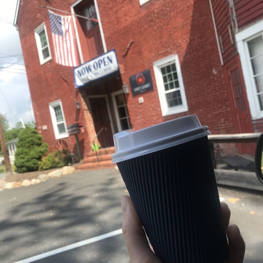 a hand holding a cup of coffee
