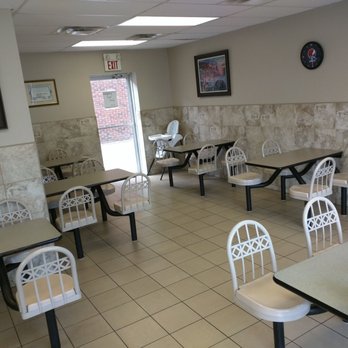 Godfathers Pizza - Bobcaygeon - a woman sitting at a table in a restaurant - Pizza Near Me - Bobcaygeon, Ontario