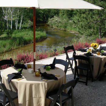 Rainbow Room Restaurant - tables and umbrellas overlooking a river - Seafood Near Me - Brutus, Michigan Rainbow Room Restaurant - tables and umbrellas overlooking a river - Seafood Near Me - Brutus, Michigan