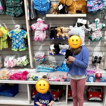 Build-A-Bear Workshop - One of several accessory walls - Children with emoji faces browsing plush toys, clothing, and accessories at Build-A-Bear Workshop store, with shelves of stuffed animals and merchandise. - Toy Stores Near Me - Lexington, Kentucky