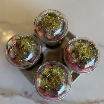 Pistachio Sweets - Overhead view of a four pack of Dubai chocolate with strawberries in a cup. - Desserts Near Me - Morton Grove, Illinois Pistachio Sweets - Overhead view of a four pack of Dubai chocolate with strawberries in a cup. - Desserts Near Me - Morton Grove, Illinois