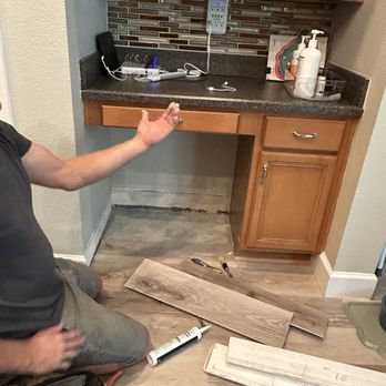 Tile Metrics - a man sitting on the floor in a kitchen - Flooring Near Me - Oviedo, Florida Tile Metrics - a man sitting on the floor in a kitchen - Flooring Near Me - Oviedo, Florida