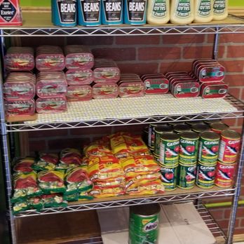 Jollof Pot - a shelf of food in a store - African Near Me - Miramar, Florida Jollof Pot - a shelf of food in a store - African Near Me - Miramar, Florida