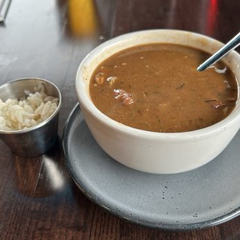 CASK Southern Kitchen & Bar - Gumbo with thimble of rice on side. - Southern Near Me - Louisville, Kentucky CASK Southern Kitchen & Bar - Gumbo with thimble of rice on side. - Southern Near Me - Louisville, Kentucky