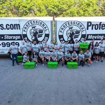 Professional Movers - Professional Movers.com team posing with moving trucks and green storage bins in Walled Lake, MI. - Movers Near Me - Walled Lake, Michigan Professional Movers - Professional Movers.com team posing with moving trucks and green storage bins in Walled Lake, MI. - Movers Near Me - Walled Lake, Michigan