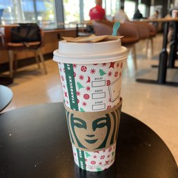 a starbucks cup on a table in a coffee shop a starbucks cup on a table in a coffee shop