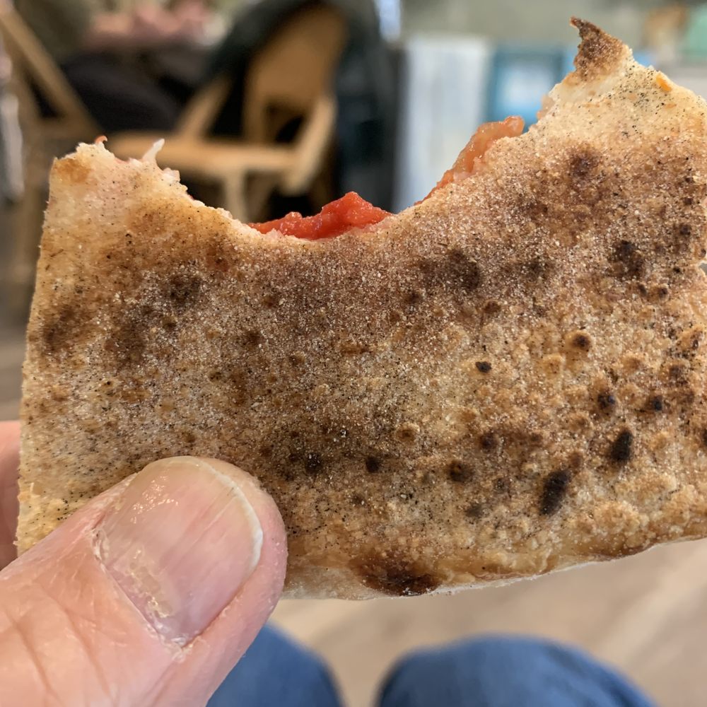Wood fired pizza crust cooked to perfection Wood fired pizza crust cooked to perfection