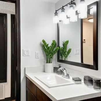 The Lorient - A bathroom with a sink and a mirror - Apartments Near Me - Pensacola, Florida