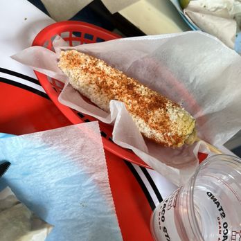 The Taco Stand - Corn On The Cob $4.00 Grilled corn served with mayonnaise, parmesan cheese and chili powder - Mexican Near Me - Oceanside, California The Taco Stand - Corn On The Cob $4.00 Grilled corn served with mayonnaise, parmesan cheese and chili powder - Mexican Near Me - Oceanside, California