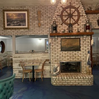 Castaways Steak & Seafood - a brick fireplace in a restaurant - Bars Near Me - Port Jefferson, New York