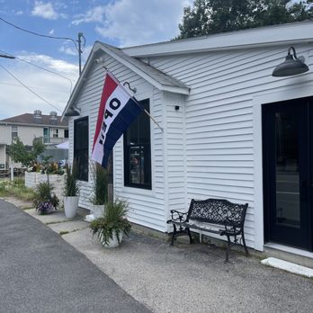 Graze + Vine - the front of a white building with a red, white, and blue flag - Wine Bars Near Me - Ogunquit, Maine