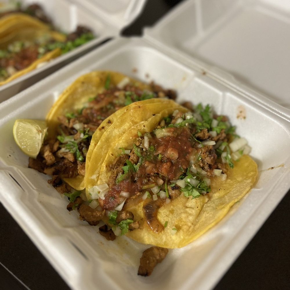 a couple of tacos in a styrofoam container a couple of tacos in a styrofoam container