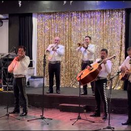 a group of musicians performing on stage a group of musicians performing on stage