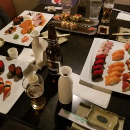 a table with sushi and beer