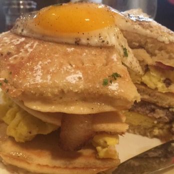 Restaurant506 - The Breakfast Tower: Pancakes Layered w/ Scrambled Eggs, Sausage, &Bacon, Topped w/ Sunny Up Egg. - New American Near Me - Arlington, Texas Restaurant506 - The Breakfast Tower: Pancakes Layered w/ Scrambled Eggs, Sausage, &Bacon, Topped w/ Sunny Up Egg. - New American Near Me - Arlington, Texas