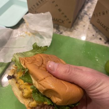Shake Shack - Shack burger.  Looks nothing like the pictures on menu.  This looks sad - Burgers Near Me - Carlsbad, California