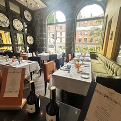 Helena - The dining room is warm and inviting, with soaring arched windows, exposed stone walls