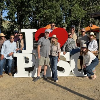 Creekcut Winery - A bunch of us piled around this super cool photo op with owners Jason and Chris in the middle! - Wineries Near Me - Paso Robles, California