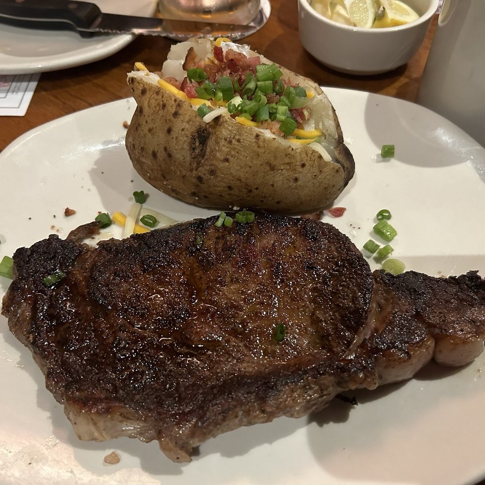 Outback Steakhouse - Ribeye Medium cooked with a baked potato. - Steakhouses Near Me - Daly City, California Outback Steakhouse - Ribeye Medium cooked with a baked potato. - Steakhouses Near Me - Daly City, California