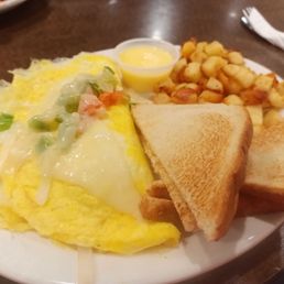 an omelet, toasted bread, and fries an omelet, toasted bread, and fries