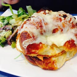 Flying With Jerome - Croissant with medium over easy egg, spinach, tomatoes, and salmon. With the choice of a side salad or fries.