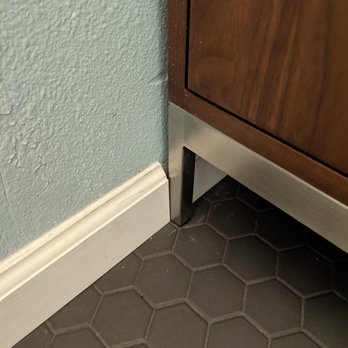 Flawless Remodeling Service - Baseboards in bathroom were installed after the vanity. So they do not fit well. - General Contractors Near Me - Wilsonville, Oregon