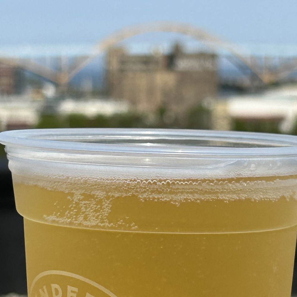 UpTop Rooftop - a hand holding a cup of beer - Beer Gardens Near Me - Milwaukee, Wisconsin UpTop Rooftop - a hand holding a cup of beer - Beer Gardens Near Me - Milwaukee, Wisconsin