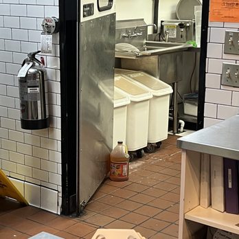 bb.q Chicken Tustin - Using a bottle of...sauce to prop the door open? Doesn't seem very sanitary. - Chicken Wings Near Me - Tustin, California