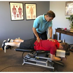 Welcare Family And Sports Chiropractic - Dr. Michael Welc adjusts a patient in a private chiropractic suite.