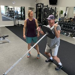 Scend Fitness - Trainer Ryan Schneider helping one of our recreational surfers get strong.