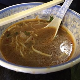 Half eaten bowl of Pho with rare meat that cooks in the broth...yum!