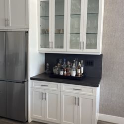 Elite Wood Working - We added to our existing cabinet to create this bar.