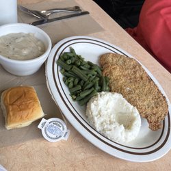 Pork loin dinner with mashed potatoes, green beans and roll