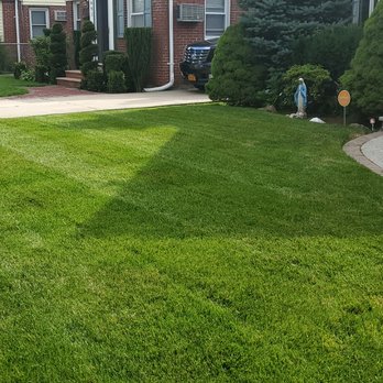 Stephens Landscaping - a man carrying a lawn mower - Landscaping Near Me - West Hempstead, New York Stephens Landscaping - a man carrying a lawn mower - Landscaping Near Me - West Hempstead, New York