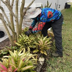 AAIM Pro Lawns - Al cleaning up a customer's flower bed.