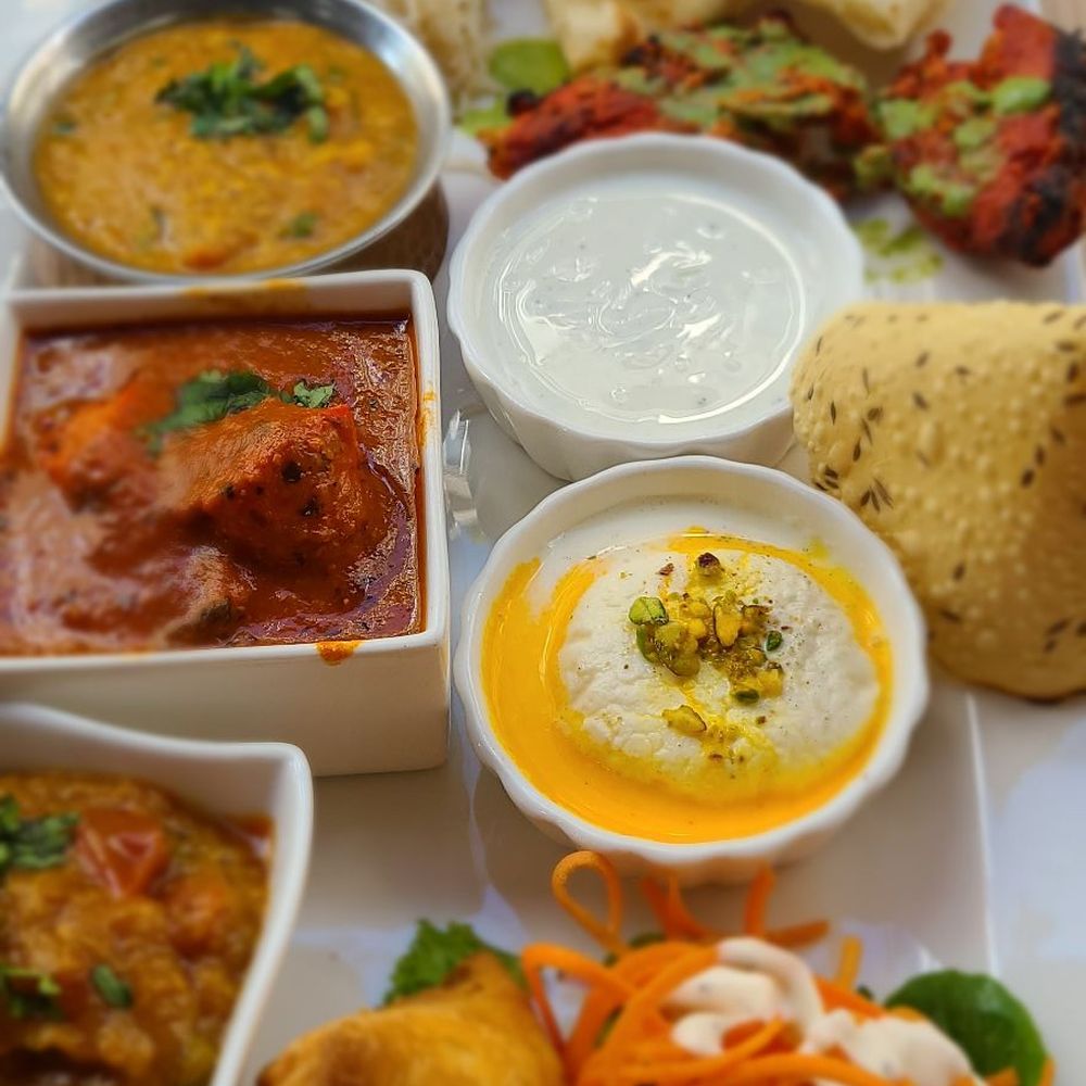 Aanch - Butter chicken thali with pappadam, samosa, peas in tomato curry, dhal, tandoori chicken, yogurt, naan, rice, carrots and rasmalai. - Indian Near Me - Toronto, Ontario Aanch - Butter chicken thali with pappadam, samosa, peas in tomato curry, dhal, tandoori chicken, yogurt, naan, rice, carrots and rasmalai. - Indian Near Me - Toronto, Ontario