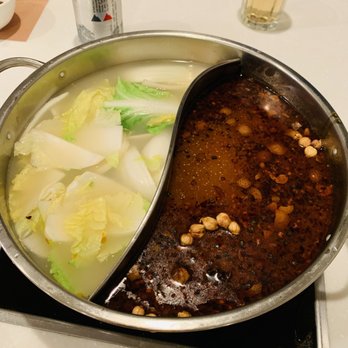 Jun Yuan - a pot of soup and vegetables on a stovetop - Hot Pot Near Me - Vancouver, British Columbia