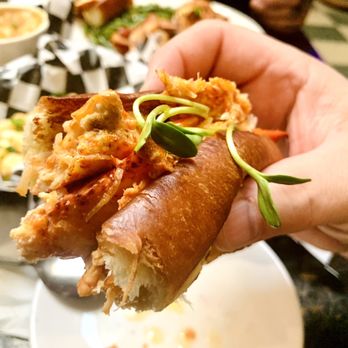 Erie Street Kitchen - a hand holding a sandwich - Seafood Near Me - Kent, Ohio Erie Street Kitchen - a hand holding a sandwich - Seafood Near Me - Kent, Ohio