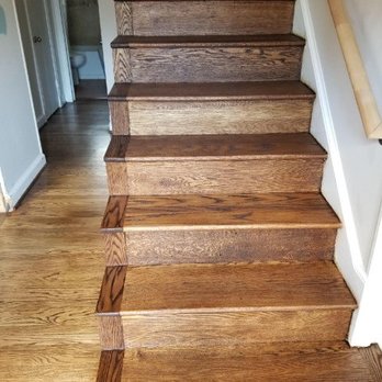 Premier Floors - a close up view of a hardwood staircase - Flooring Near Me