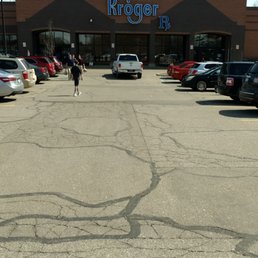 a person riding a bike in a parking lot