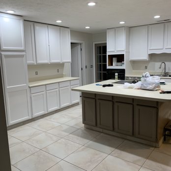 Four Corner Solutions - a kitchen with white cabinets - Painters Near Me